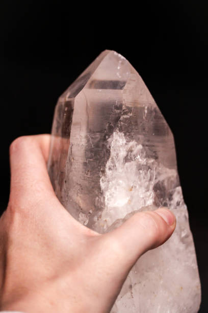 istock Hand holding mountain crystal berg clear quartz 914123112