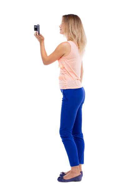 istock back view of standing young beautiful  woman  and using a mobile 914123768