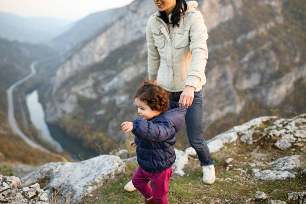 istock Mother and daughter on mountain top 914123982