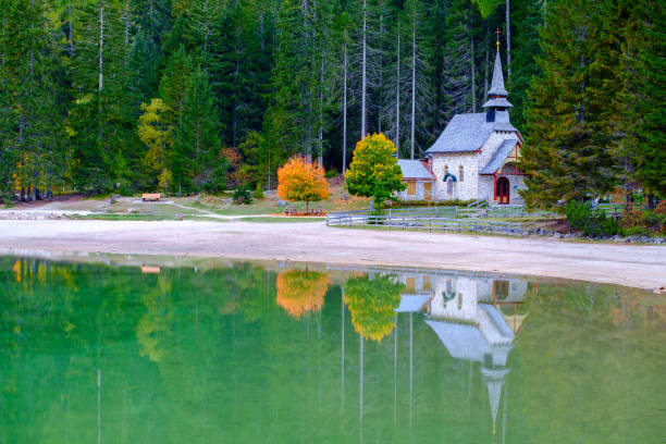 istock Little chapel at the Braies Lake in Dolomites mountains 914129984