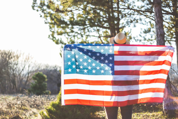 istock Young woman holding USA flag 914134502