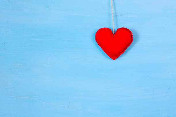 istock Red heart on string. Romantic love vintage wooden background 914137400