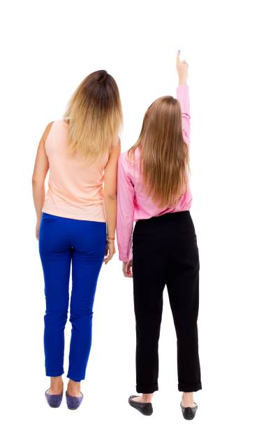 istock Back view of two pointing young girl. 914137516
