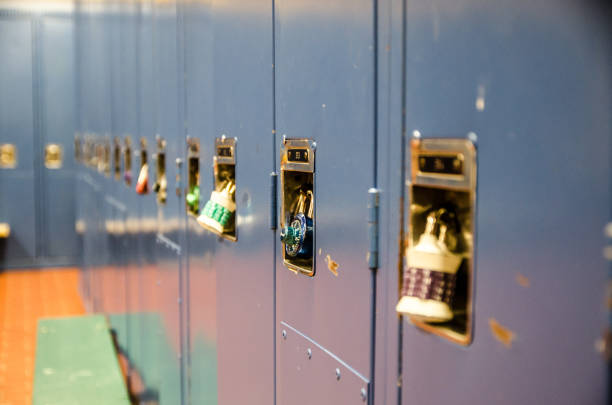 istock Side view of row of school blue lockers with combination locks 914140718