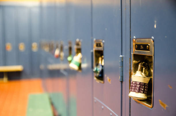 istock Side view of row of school blue lockers with combination locks 914140770