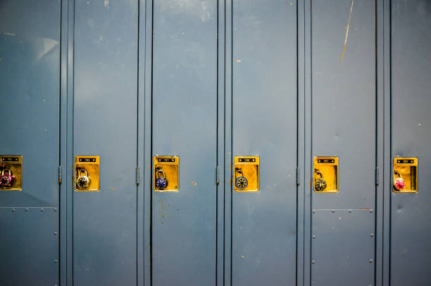 istock Front view of row of school blue lockers with combination locks 914140804