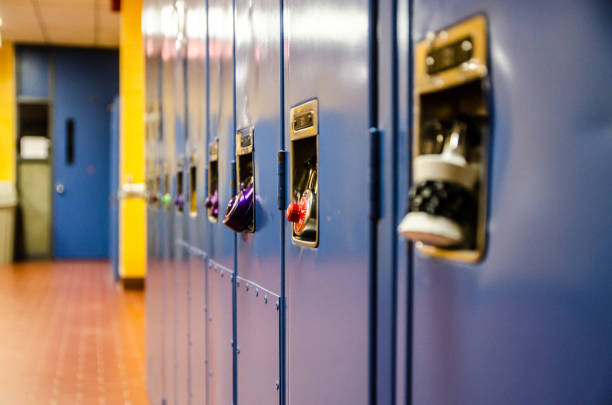 istock Side view of row of school blue lockers with combination locks 914141030