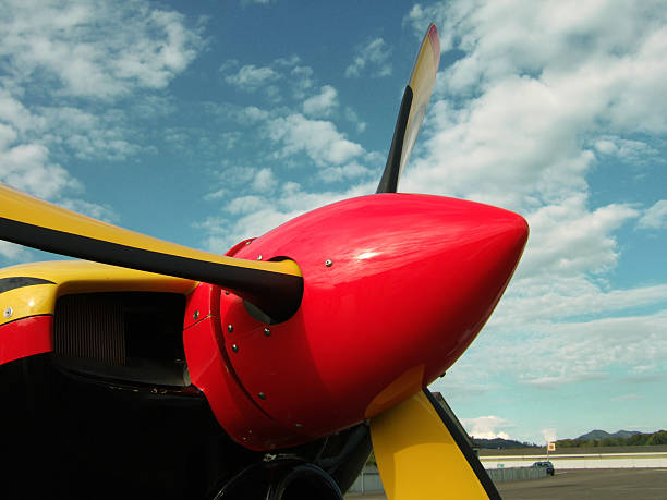 istock Red-yellow airplane propeller against blue partially clouded sky 91414185