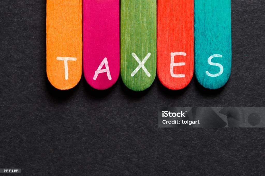 Taxes Word on Wood Block Block Shape Stock Photo