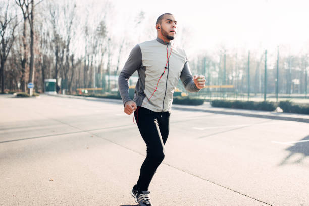 istock Jogger in motion, running in autumn park 914145384