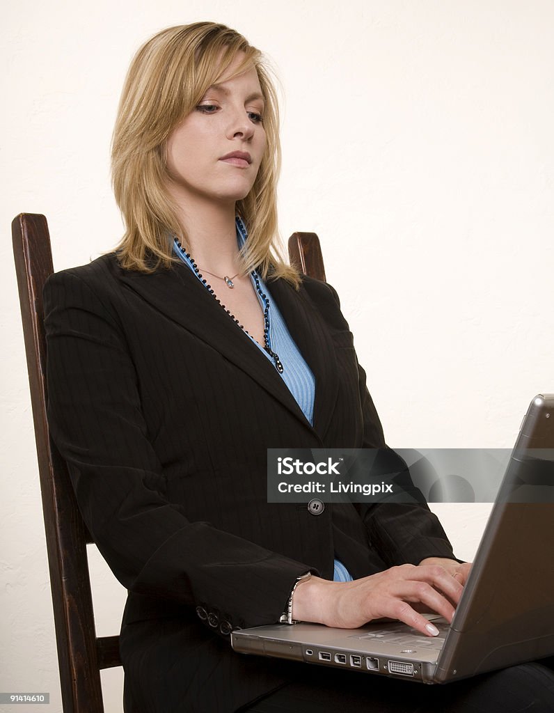 Serious young attractive businesswoman works on her laptop  20-29 Years Stock Photo