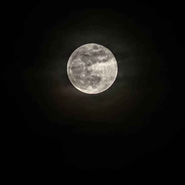 istock Full moon over dark black sky at night 914149288
