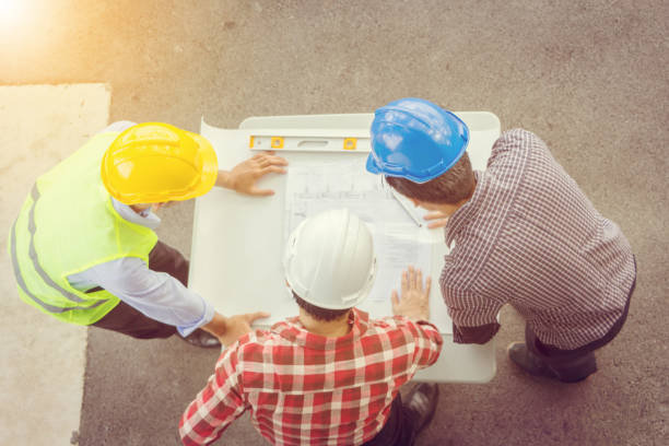 istock Team of Architect engineer planning group project partners meeting at building site, Construction site office teamwork concept 914151770