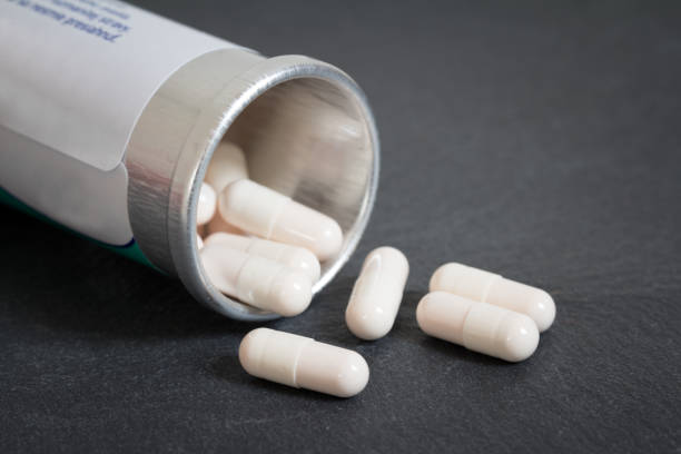 istock white pills spilling out of pill bottle 914154514