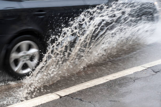 istock car driving through a flooded road 914157524