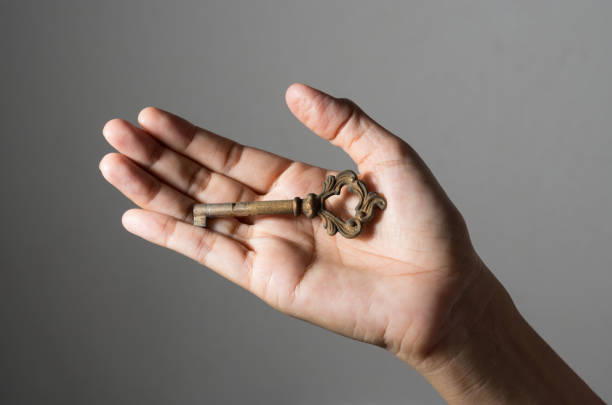 istock Old key in girl hand. 914157798