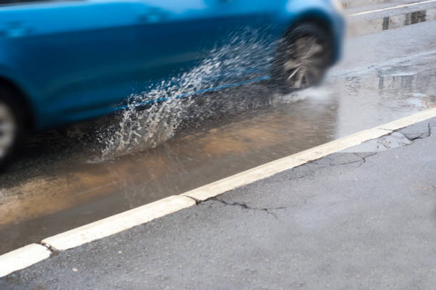 istock car driving through a flooded road 914157962