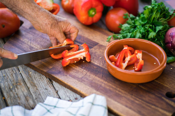 istock Senior man cutting red bell pepper 914162304