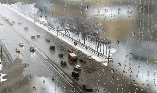 istock Traffic in heavy snowy day with road view inside the misted home window 914162892