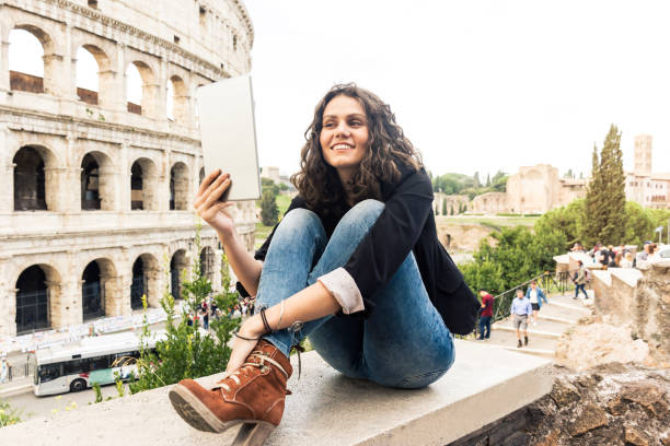 istock Smiling woman in front of Colosseum 914165408