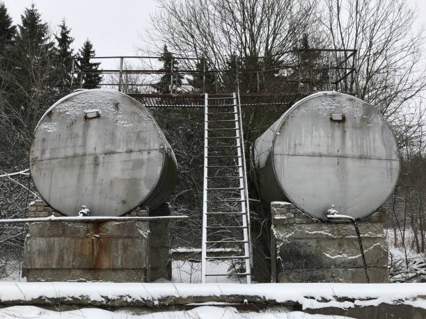 istock Old rusty abandoned metal cisterns in the winter forest 914169268