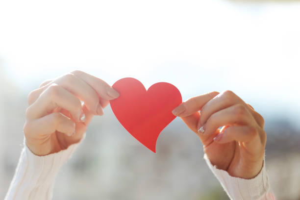 istock Young woman between hand red heart 914172616