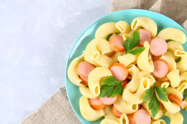 istock Pasta Cavatappi or Cellentani with sausages on a gray table. 914173302