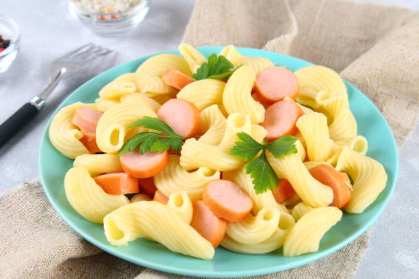 istock Pasta Cavatappi or Cellentani with sausages on a gray table. 914173306