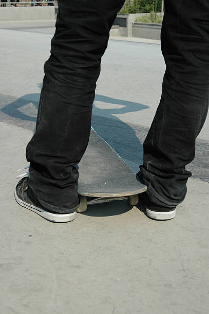 istock Skateboarder stands waiting with board between his feet. 91417500