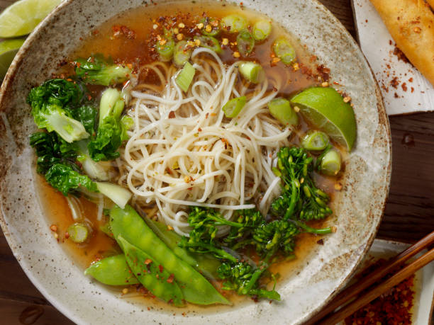 Ramen Noodle and Vegetable Soup Ramen Noodle and Vegetable Soup with Broccoli, Bok Choy,Snow peas, Green Onions, Lime and Chili Flakes noodle soup photos stock pictures, royalty-free photos & images
