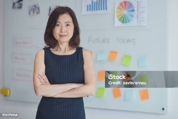Portrait Of Businesswoman Against Whiteboard Stock Photo - Download Image Now - Office, Business, Portrait