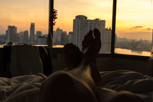 Man resting and seeing the aerial view of the the Bangkok skyline, Thailand
