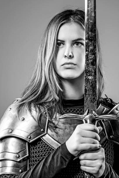 istock Sword wielding viking warrior young blond female in studio shot 914192838