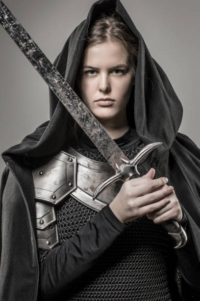 istock Sword wielding viking warrior young blond female in studio shot 914192844