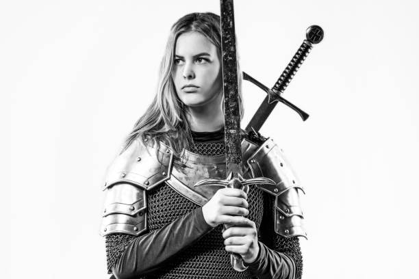 Sword wielding viking warrior young blond female in studio shot