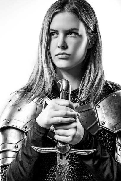 istock Sword wielding viking warrior young blond female in studio shot 914192902