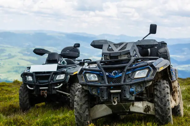 Motorsport in the mountains. Two ATVs on top of a mountain