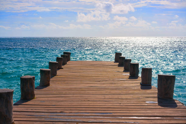 Riviera Maya wood pier with Caribbean boats in Mexico