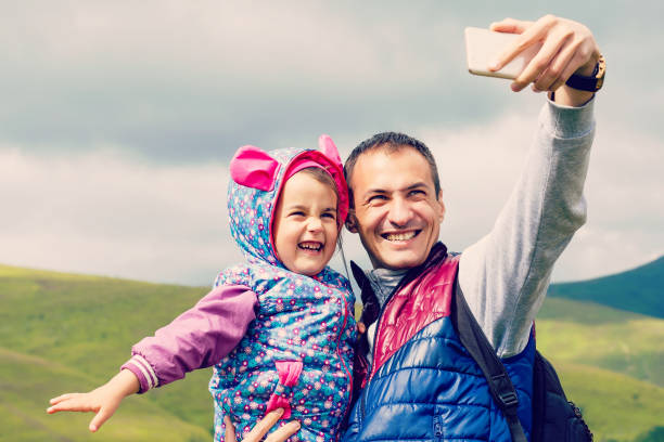istock father with little daughter making selfie while hiking in summer mountains 914204270
