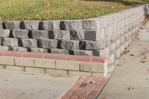 istock Residential retaining wall featuring a variety of stacked blocks and mortared brick textures 914214792