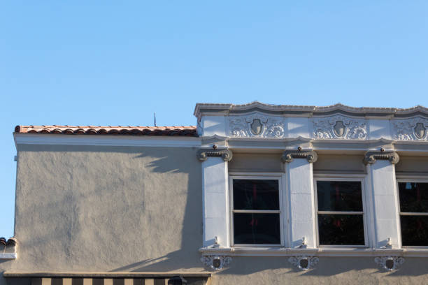 istock Roofline of a building with both plain stucco and ornamental window facing 914214836