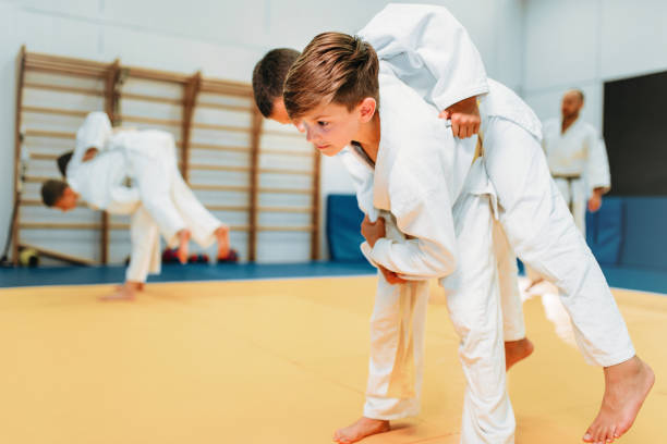 istock Kid judo, young fighters on training, self-defense 914220262