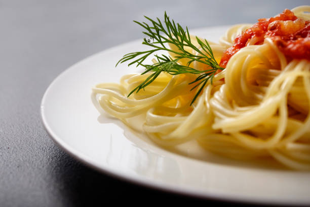 Vegetarian pasta. Spaghetti with tomato sauce and cheese close-up. With space for text.