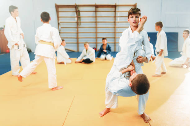 istock Boys in kimono fights, kid judo training 914220858