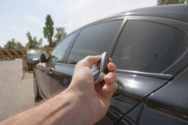 istock hand presses on the remote control car alarm systems 914227476