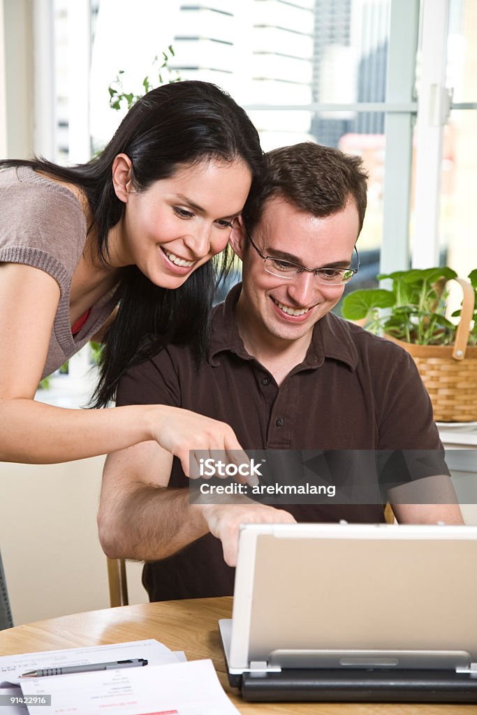 Couple paying bills by online banking  20-29 Years Stock Photo