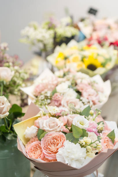 istock Bouquets on table, florist business. Different varieties fresh spring flowers. Delivery service. Flower shop concept. 914231168