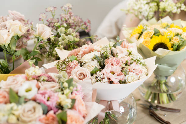 istock Bouquets on table, florist business. Different varieties fresh spring flowers. Delivery service. Flower shop concept. 914231234