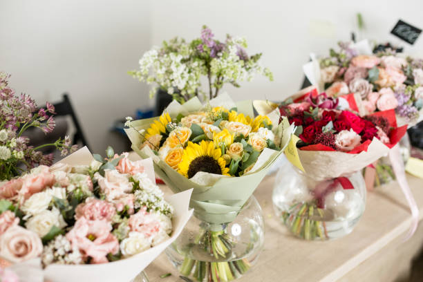 istock Bouquets on table, florist business. Different varieties fresh spring flowers. Delivery service. Flower shop concept. 914231278