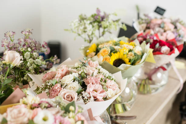 istock Bouquets on table, florist business. Different varieties fresh spring flowers. Delivery service. Flower shop concept. 914231334
